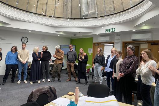 The Innovation Unit team standing in a circle