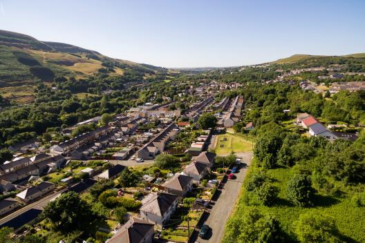A valley full of trees and houses on a sunny day