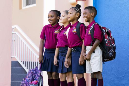 Four school children standing in a line