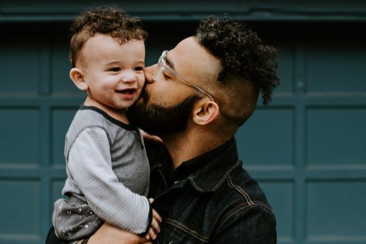 A man holding a smiling child