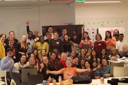 A big group of people smiling with joy at the camera