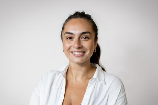 Sarah smiling and looking at the camera
