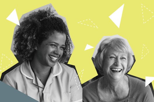 A carer and an older woman sat together laughing