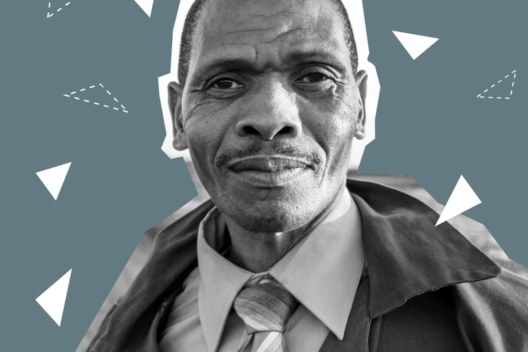 An older Black man looks at the camera