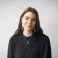 Sophie smiling at the camera. She's a white woman with long brunette hair, wearing a black knitted jump and large silver earrings.