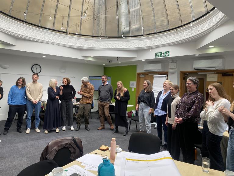 The Innovation Unit team standing in a circle