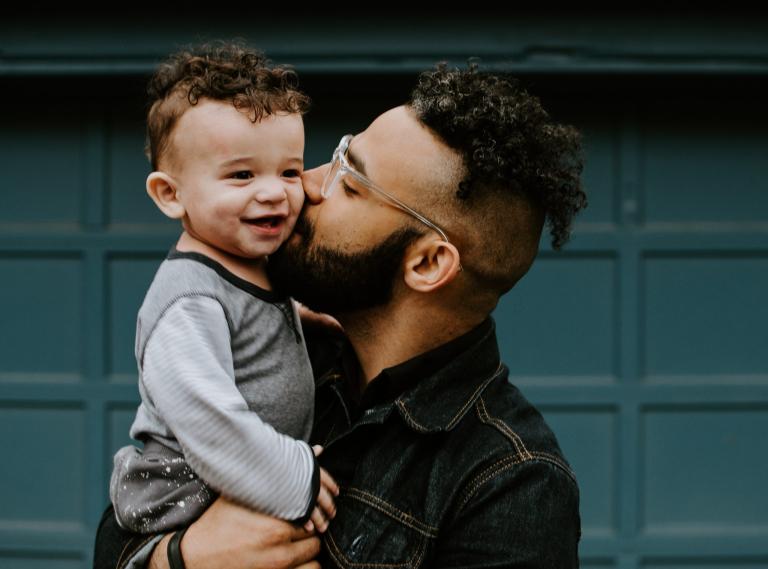 A man holding a smiling child