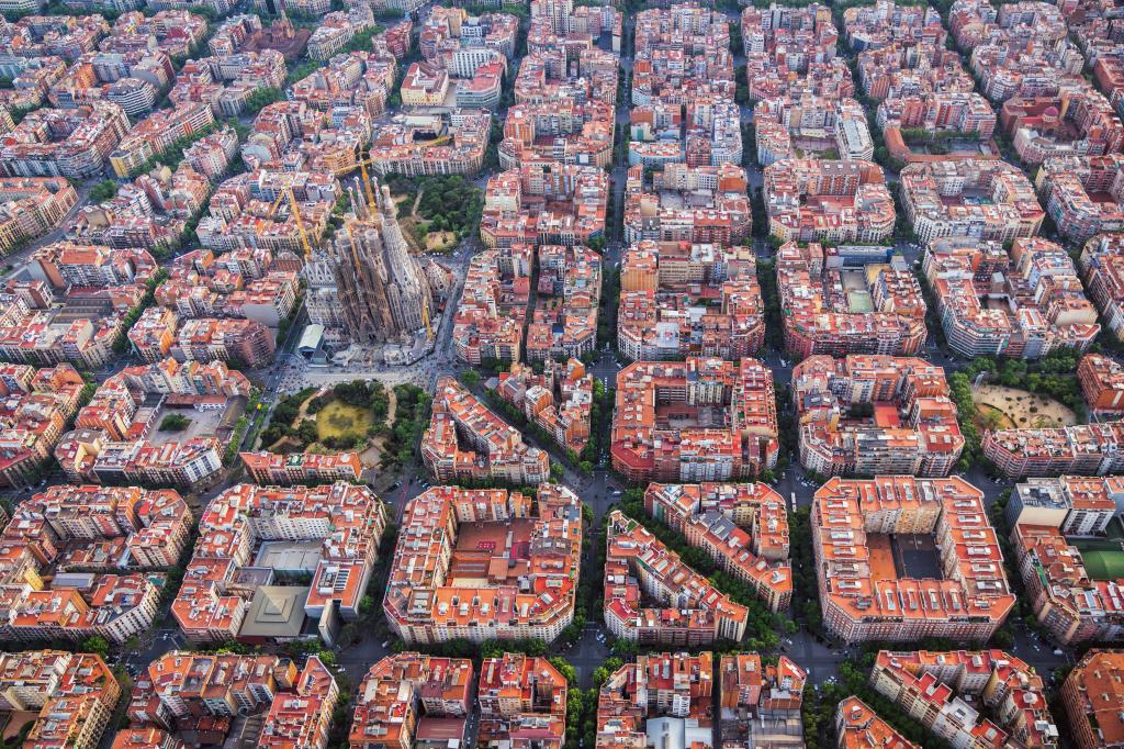 Aerial view of Barcelona Eixample residential district and Sagrada familia, Spain. Late afternoon light