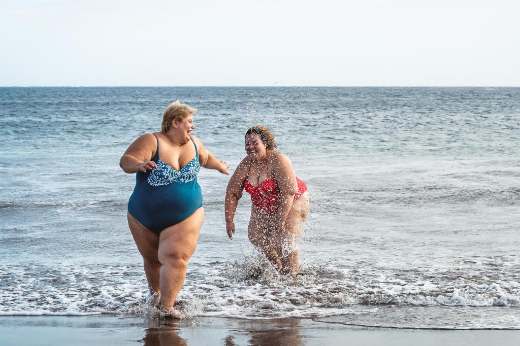 Two white women running out of the sea