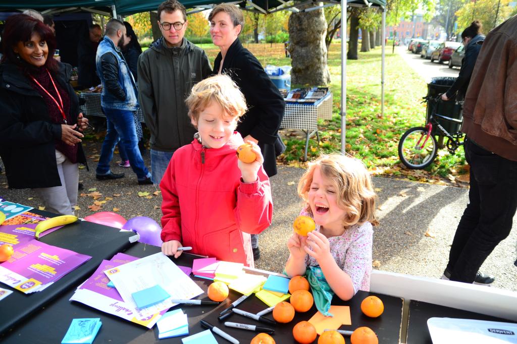 Two children eating fruit