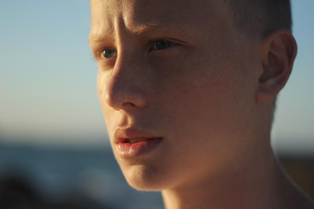 A 12 year old boy looking into the sun