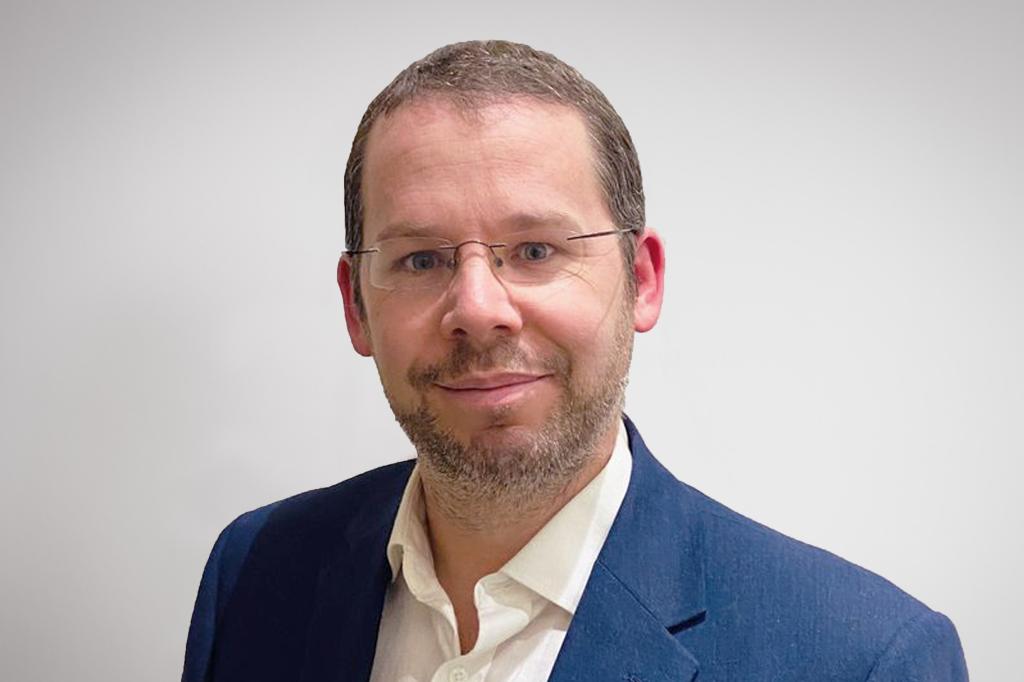 Sebastien Chapleau wearing glasses, blue blazer and white shirt. 