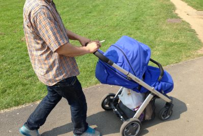 Young man and baby taking a walk in the park