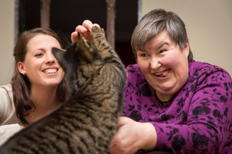 Two women and a cat