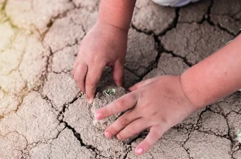 Baby's feet on dry ground
