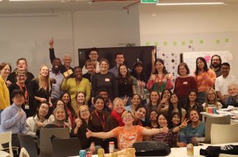 exhausted but smiling, the service design jam participants pose for a group photo